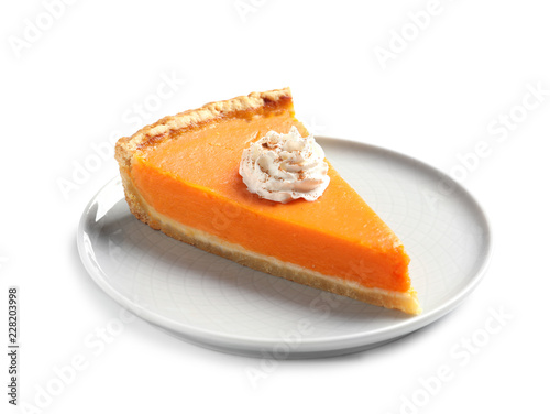 Plate with piece of fresh delicious homemade pumpkin pie on white background