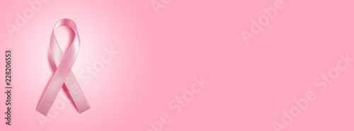 Photo pink ribbon on pink background with copy space