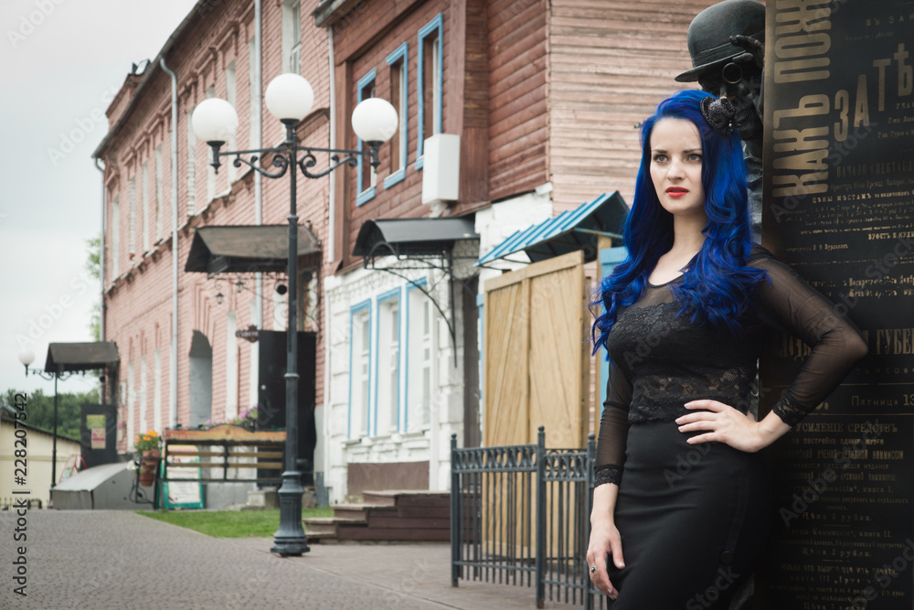 Rock girl with blue hair on a city street