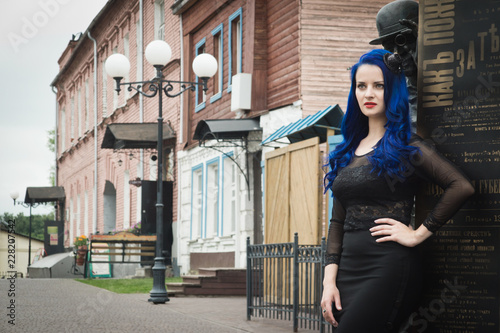 Rock girl with blue hair on a city street