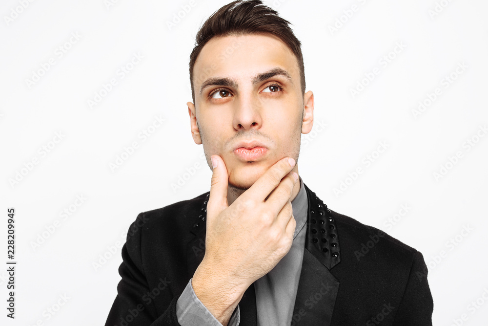 Pensive business man in black suit isolated on white background Pensive business man in black suit isolated on white background