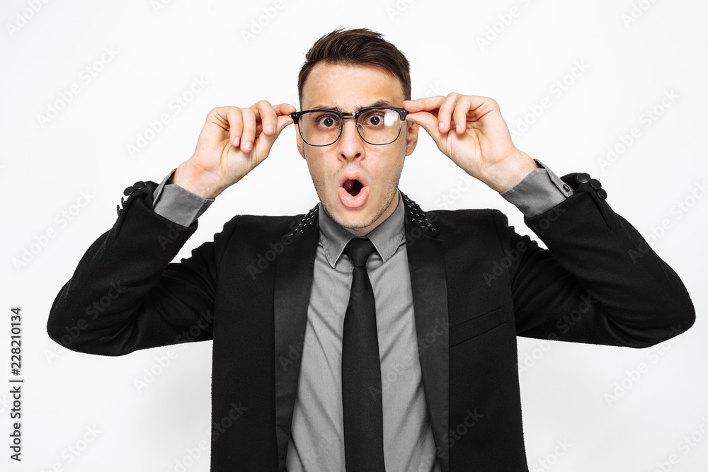Business man in glasses and suit, amazingly shocked, with big eyes and open mouth, isolated on white background Business man in glasses and suit, amazingly shocked, with big eyes and open mouth, isolated on white background