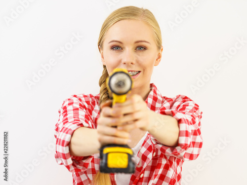 Woman aiming with drill