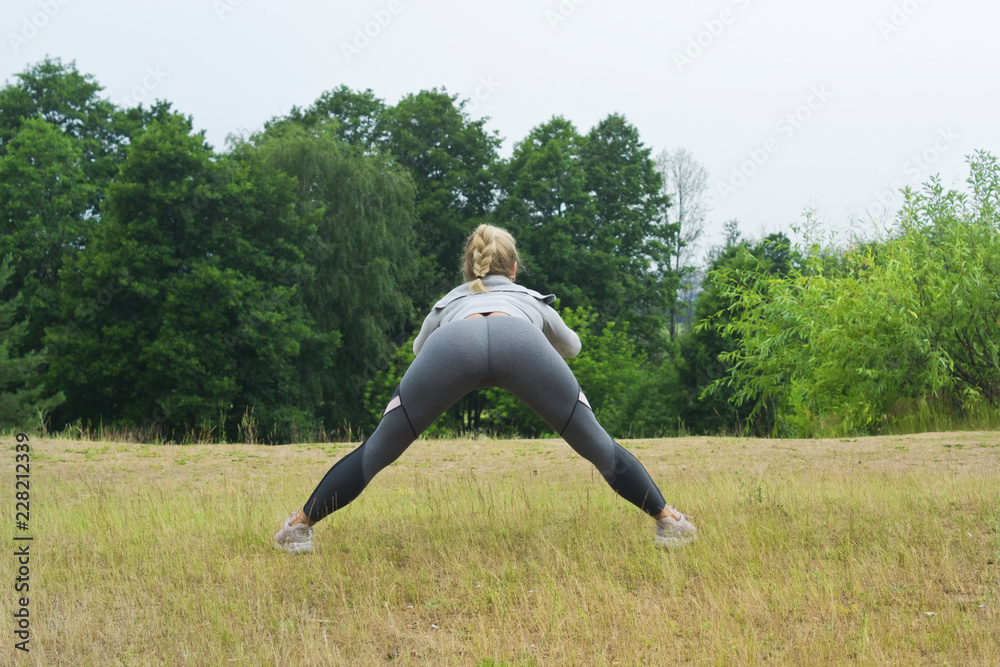 Fit women stretching the muscles of her legs Fit women stretching the muscles of her legs