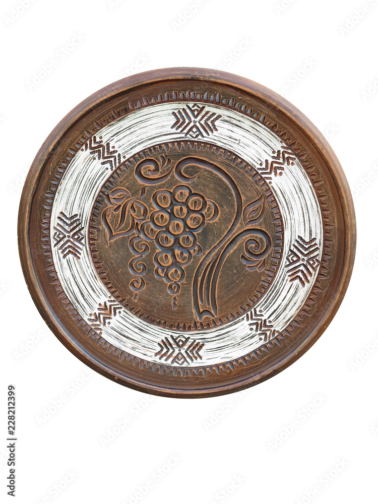 Old handmade ornated brown pottery plate isolated on white Old handmade ornated brown pottery plate isolated on white