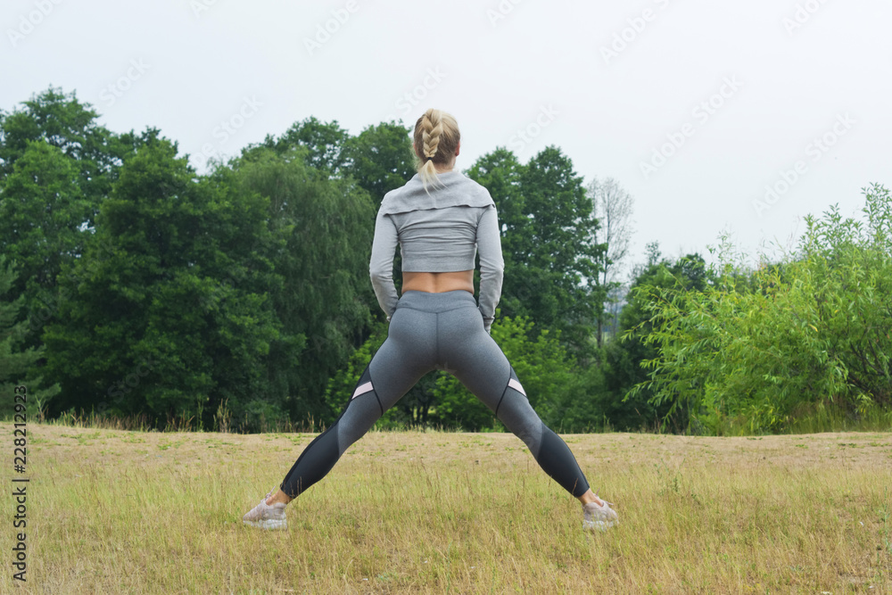 Fit women stretching the muscles of her legs Fit women stretching the muscles of her legs