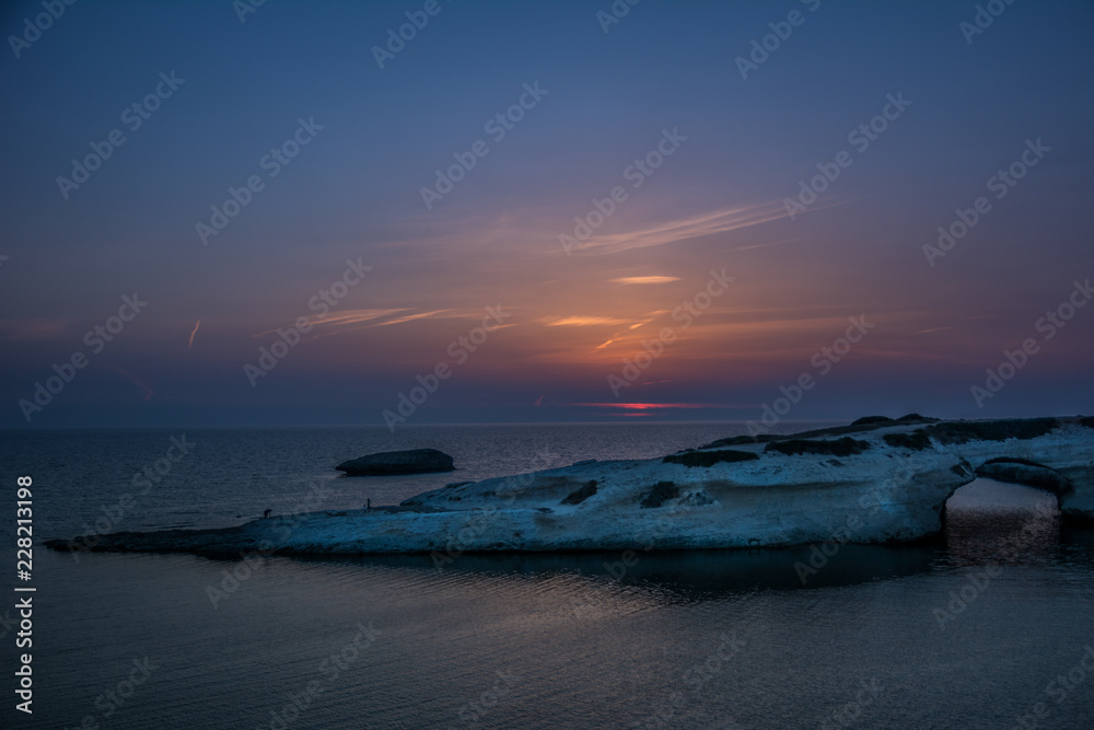 Limestone rock with arch, S`Archittu di Santa Caterina in Oristano Province, Sardinia, Italy captured in summer at dusk.