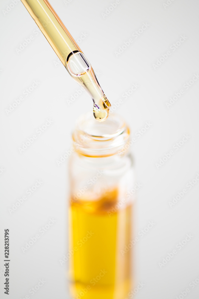 Orange Pipette Dropper on White Background Orange Pipette Dropper on White Background