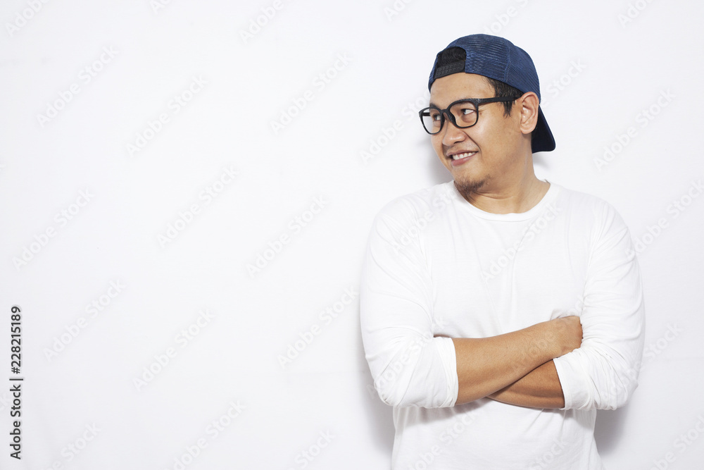 Young Asian Man Smiling Happily, Looking to the Side Young Asian Man Smiling Happily, Looking to the Side