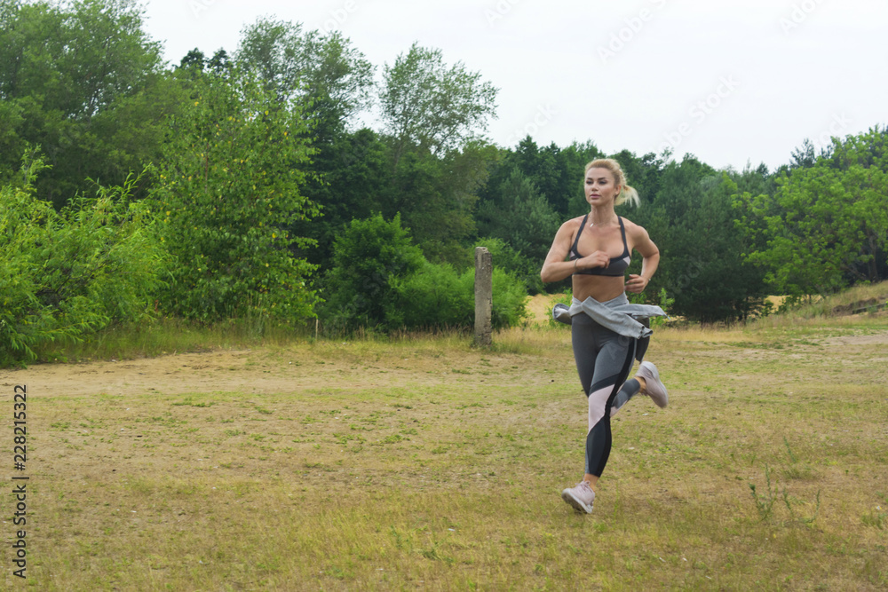 Woman running in green park on summer day