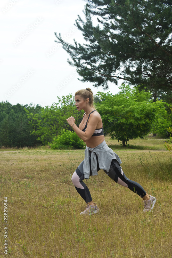 Fit women stretching the muscles of her legs Fit women stretching the muscles of her legs