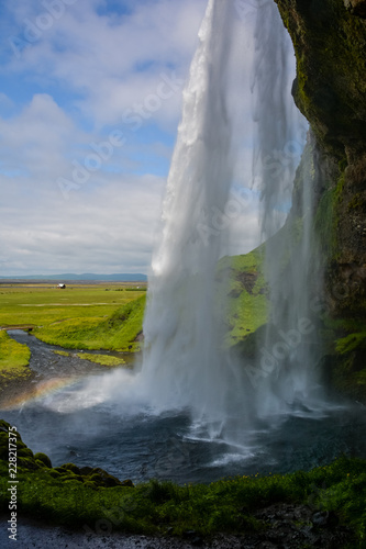 Seljalandsfoss waterfall, Iceland - view from below with rainbow