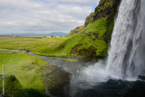 Fototapeta Naklejka Na Ścianę i Meble -  Seljalandsfoss waterfall, Iceland - view from below with rainbow