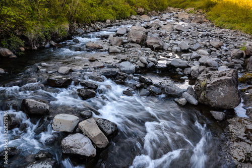 View in Skaftafell national park to the river and stones  water in motion blur  Iceland in summer