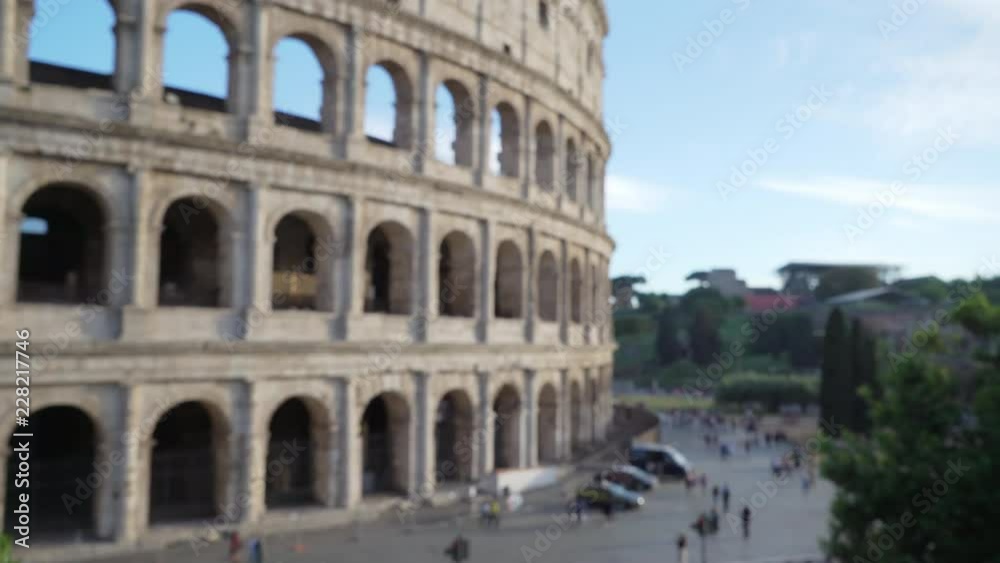 Afternoon in front of Roman Colosseum with tourists walking around Afternoon in front of Roman Colosseum with tourists walking around