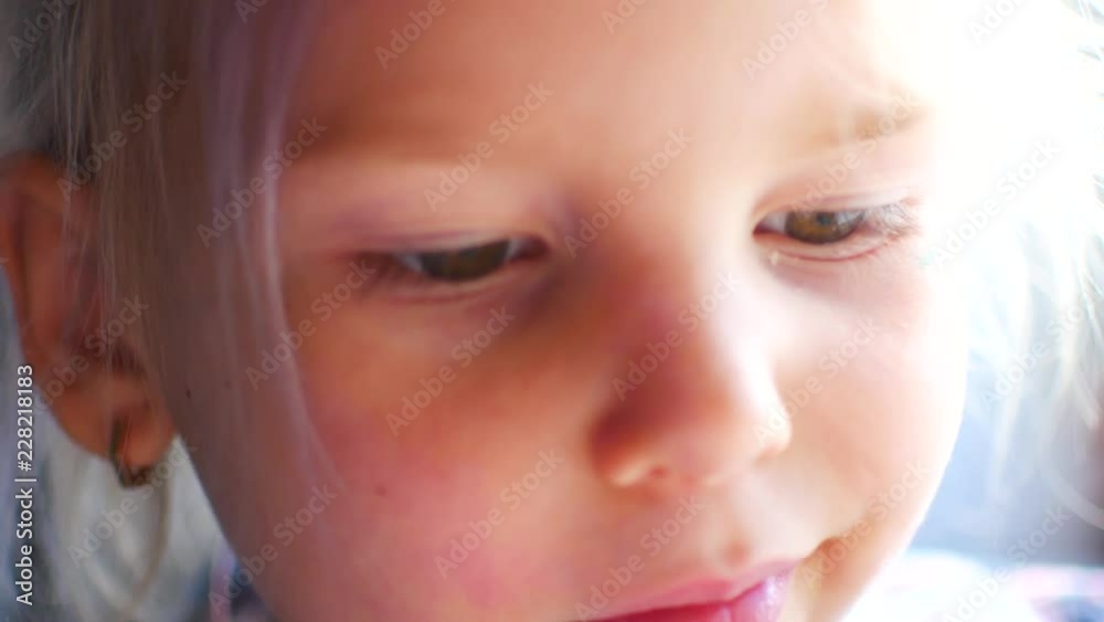 Beautiful girl makes faces. Cute blonde child. Brown eyes. Close up Beautiful girl makes faces. Cute blonde child. Brown eyes. Close up