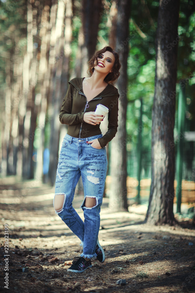 Beautiful model wearing casual wear id holding paper cup in her hand Beautiful model wearing casual wear id holding paper cup in her hand