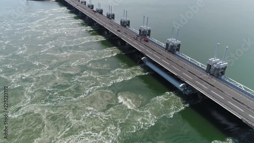 Aerial footage of Eastern Scheldt storm surge barrier in dutch Oosterscheldekering is largest of Delta Works series of dams and barriers designed to protect Netherlands from flooding 4k quality photo