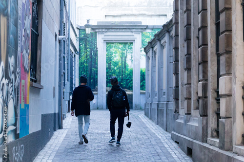 Male travelers Two people walk in the streets of Old Town of Brussels.