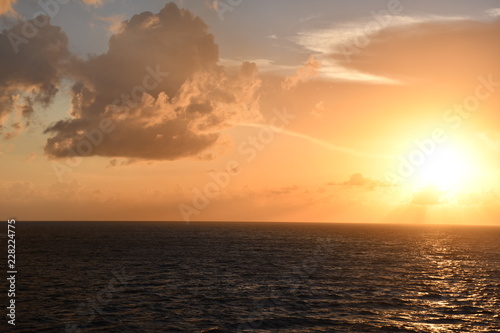 sunsets ocean blue sky clouds ocean waves sea  © Stathie