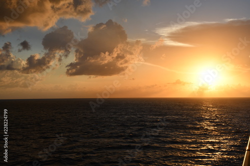 sunsets ocean blue sky clouds ocean waves sea  © Stathie