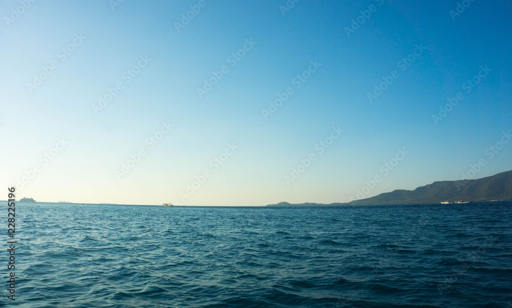 a small island see from distance with blue sea and clear sky
