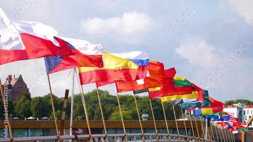 Flags of many nations waving together in a display of unity, slow motion. photo