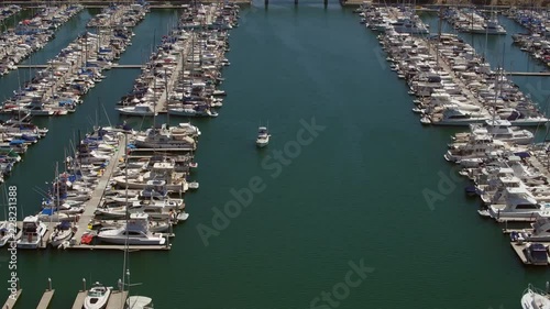 California‚Äôs Dana Point harbor with tall ships, sailboats, powerboats and paddleboarder. photo