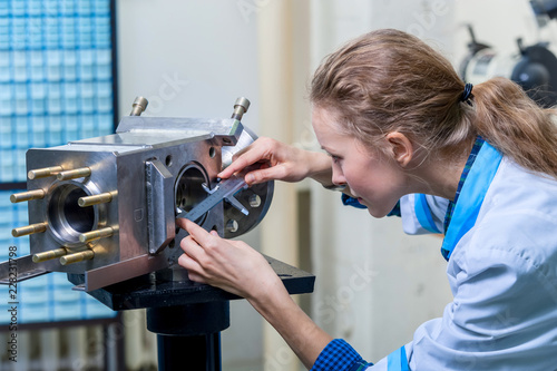 Woman mechanic with a caliper measuring device photo