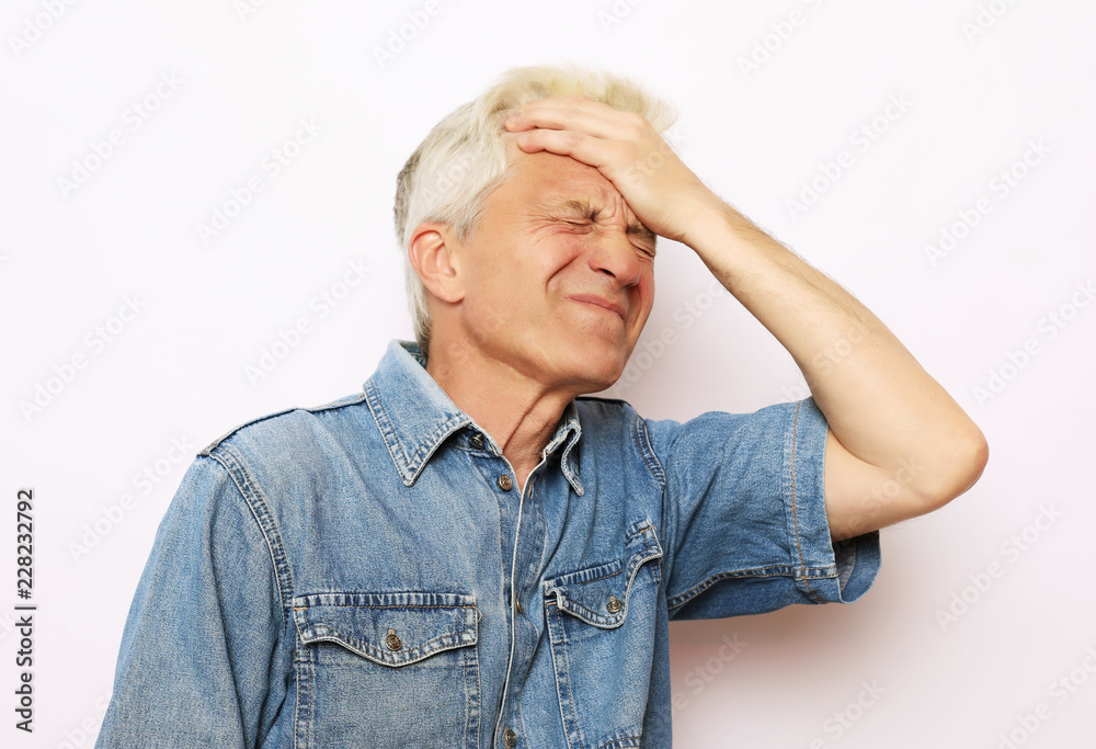lifestyle, health and people concept: Senior man has headache, on white background lifestyle, health and people concept: Senior man has headache, on white background