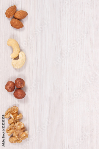 Different nuts and almonds as source vitamins and minerals, copy space for text on white board