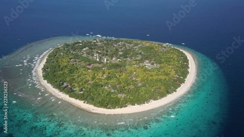 Aerial forward tracking shot panning down of Balicasag Island, Bohol, the Philippines photo