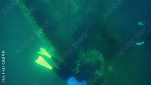 Swimming freediving underwater at shipwreck. Lusong Gunboat, Coron, Philippines. photo