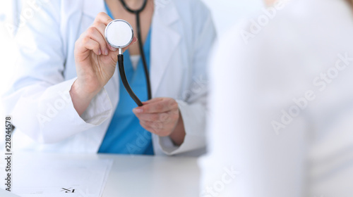 Medicine doctor hold stethoscope head closeup. Physician ready to examine and help patient. Medical help and insurance in health care, best treatment concept