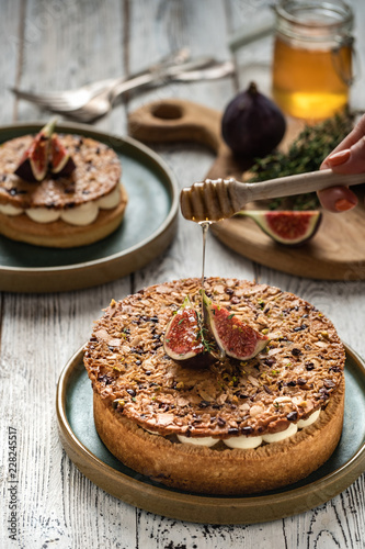 Tarte on sand base with fresh figs, almonds and crispy waffle with almonds and cocoa powder. Fresh Homemade Fruit Tart with berries photo