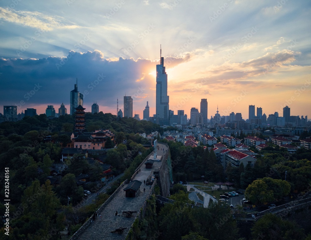Obraz premium Sunset behind the skyscraper which is the tallest building in Nanjing city taken with a drone in the air.