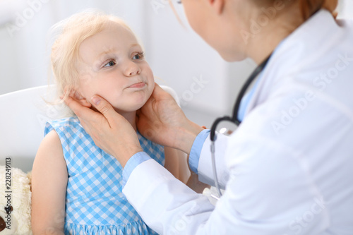 Doctor and a little blonde girl. Medicine and healthcare concept
