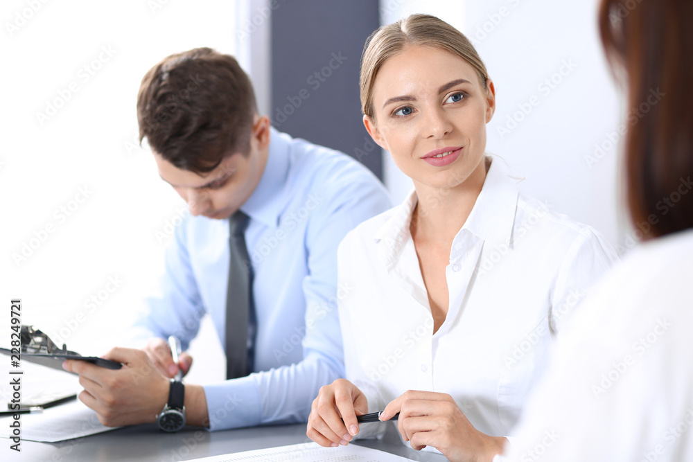 Group of business people or lawyers discussing terms of transaction in office. Meeting and teamwork concept Group of business people or lawyers discussing terms of transaction in office. Meeting and teamwork concept
