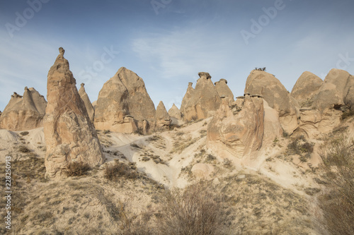 Unreal world of Cappadocia. Colorful sunrise in Red Rose valley in April. Cavusin village located, Nevsehir Province in the Cappadocia region of Turkey, Asia. Traveling concept background