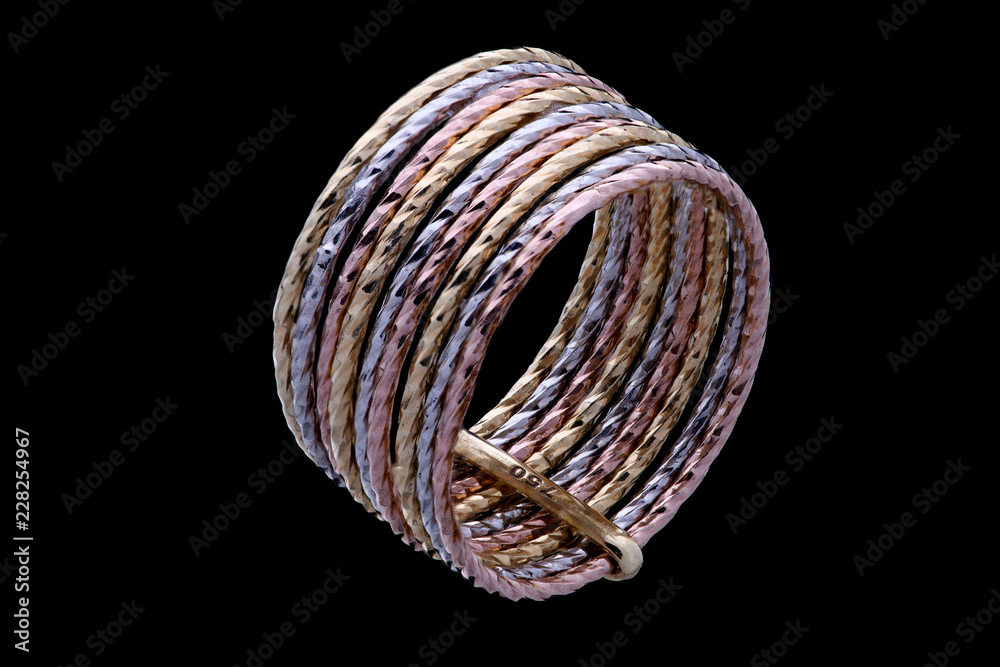 Fototapeta premium Golden ring with three color of gold on a black background