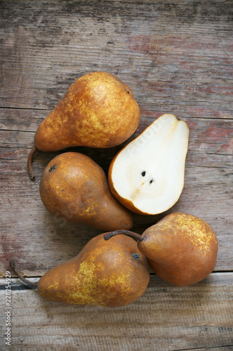 Brown pears on rustic wood
