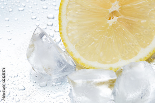 Lemon ring with ice on a silvery background closeup photo