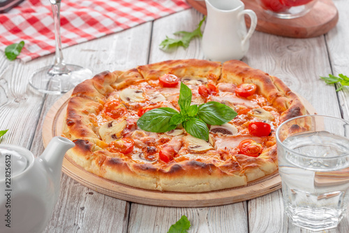 Delicious fresh pizza served on wooden table