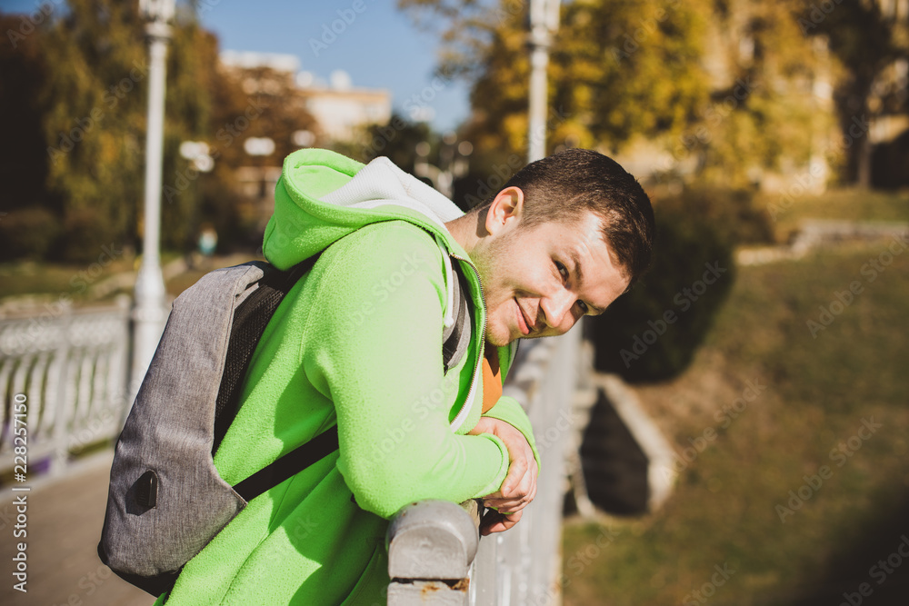 Nice man outdoors portrait. Guy at city streets, smiling people concept, good mood and positive emotions Nice man outdoors portrait. Guy at city streets, smiling people concept, good mood and positive emotions