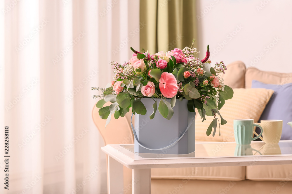 Fototapeta premium Gift box with beautiful flowers on table indoors