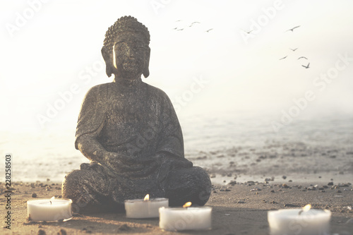 temple with buddha statue and lit candles that illuminate the spirit photo