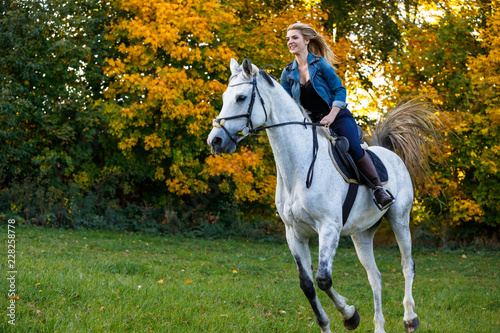 Woman horse riding in park