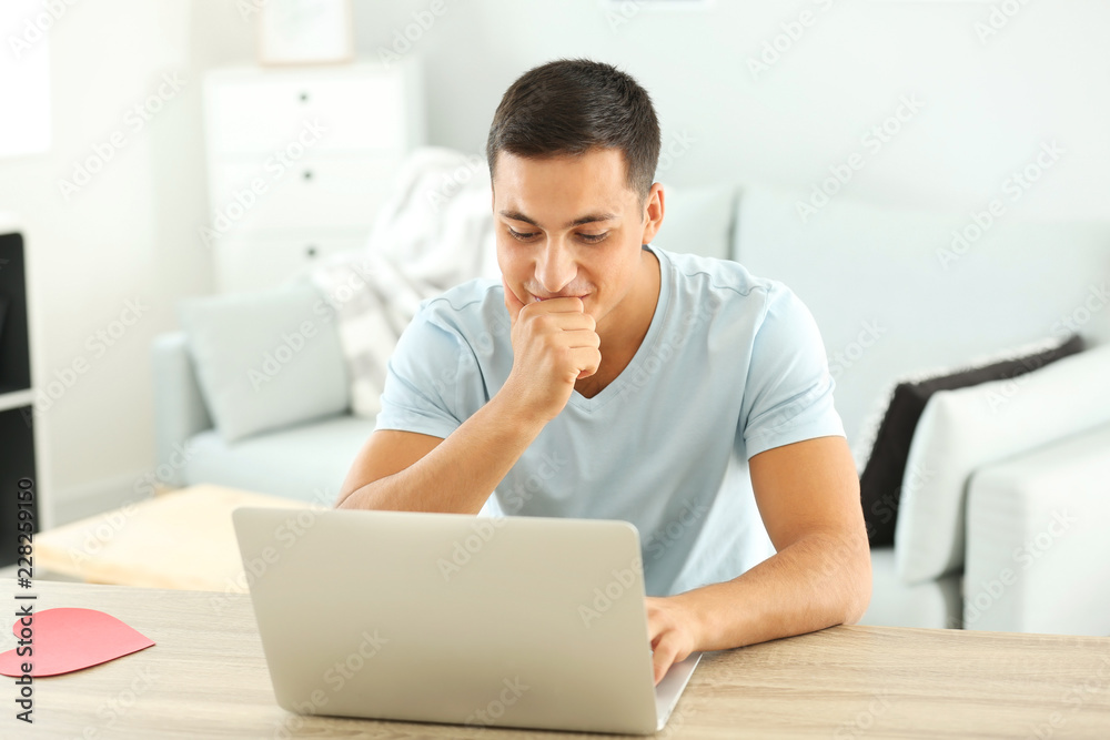 Young man having online dating at home Young man having online dating at home