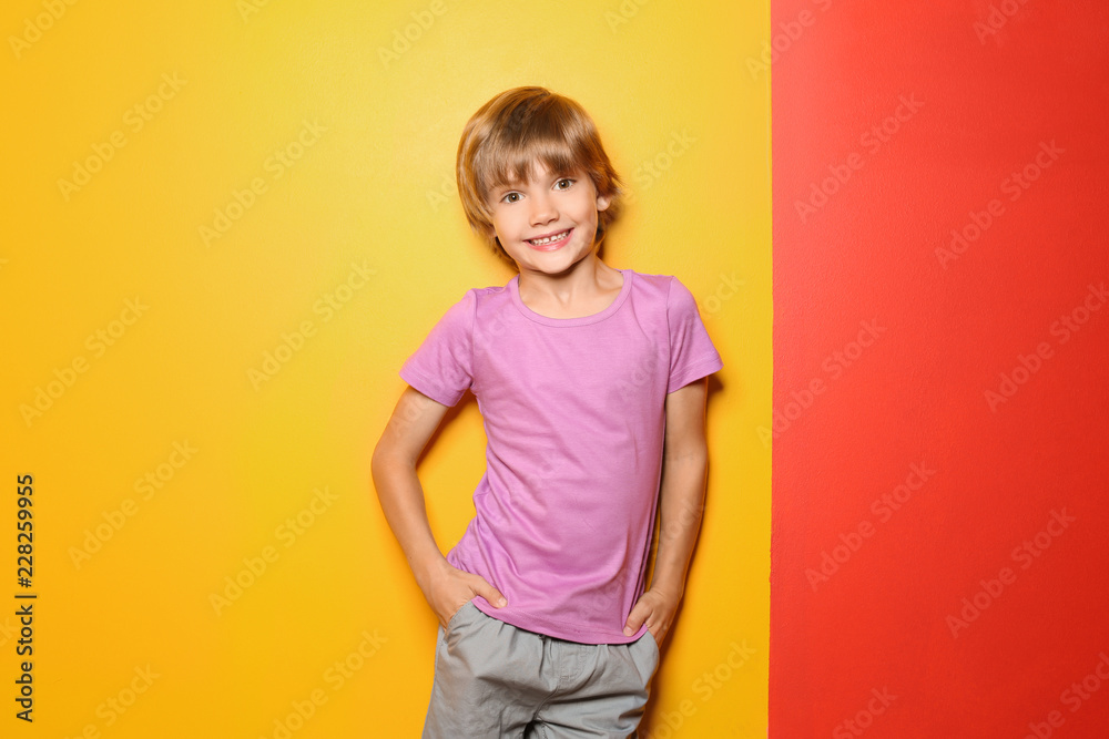 Little boy in t-shirt on color background