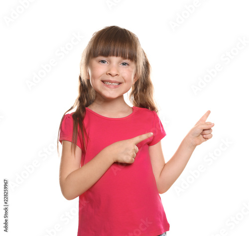 Little girl in t-shirt poin...